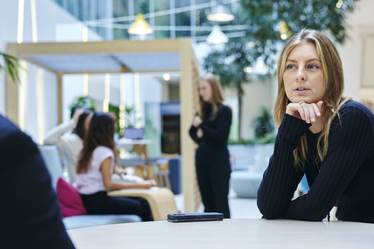 people in conversation with blurred people in background