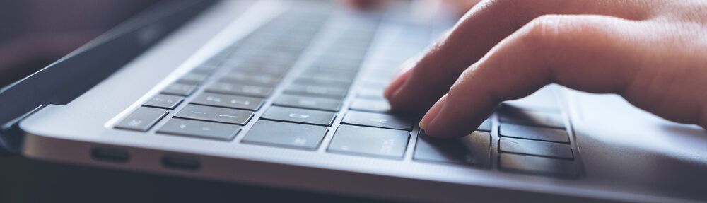 close hand typing on a keyboard