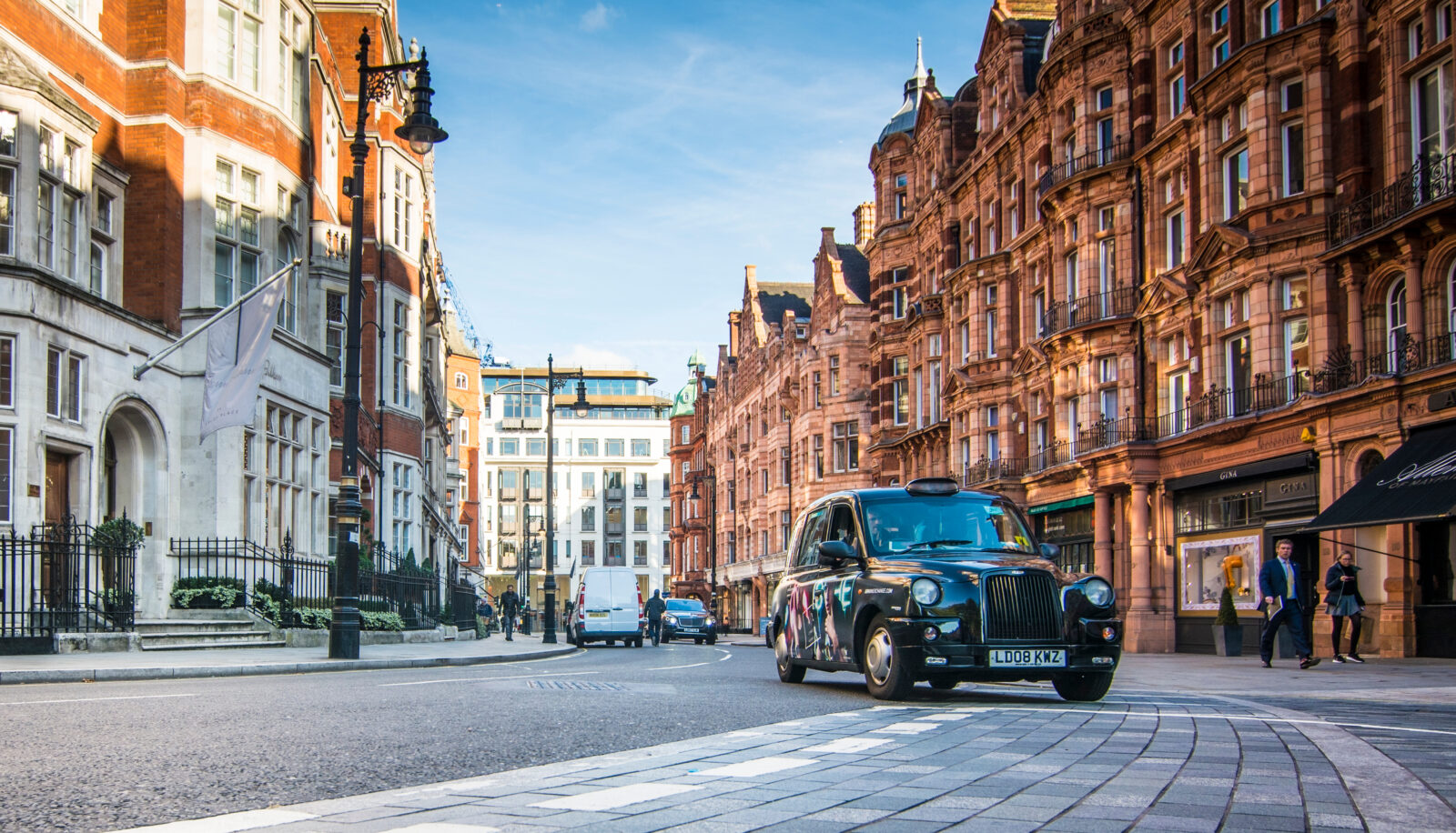 Buildings in London and a black taxi