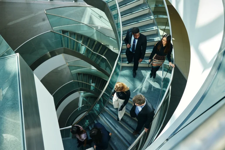 People walking down a spiral staircase