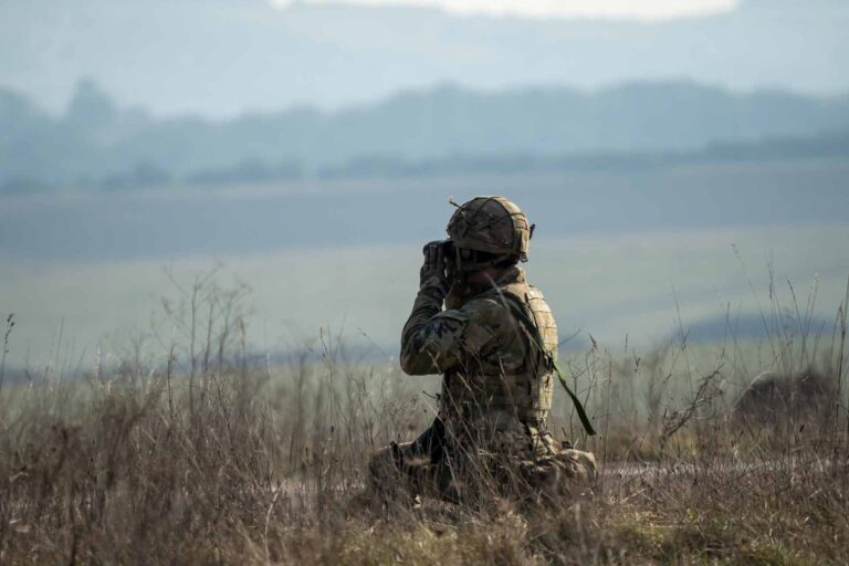defence sector represented by an army soldier looking through binoculours