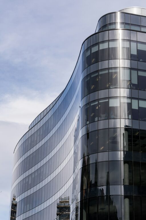 Large corporate glass building in front of a blue sky
