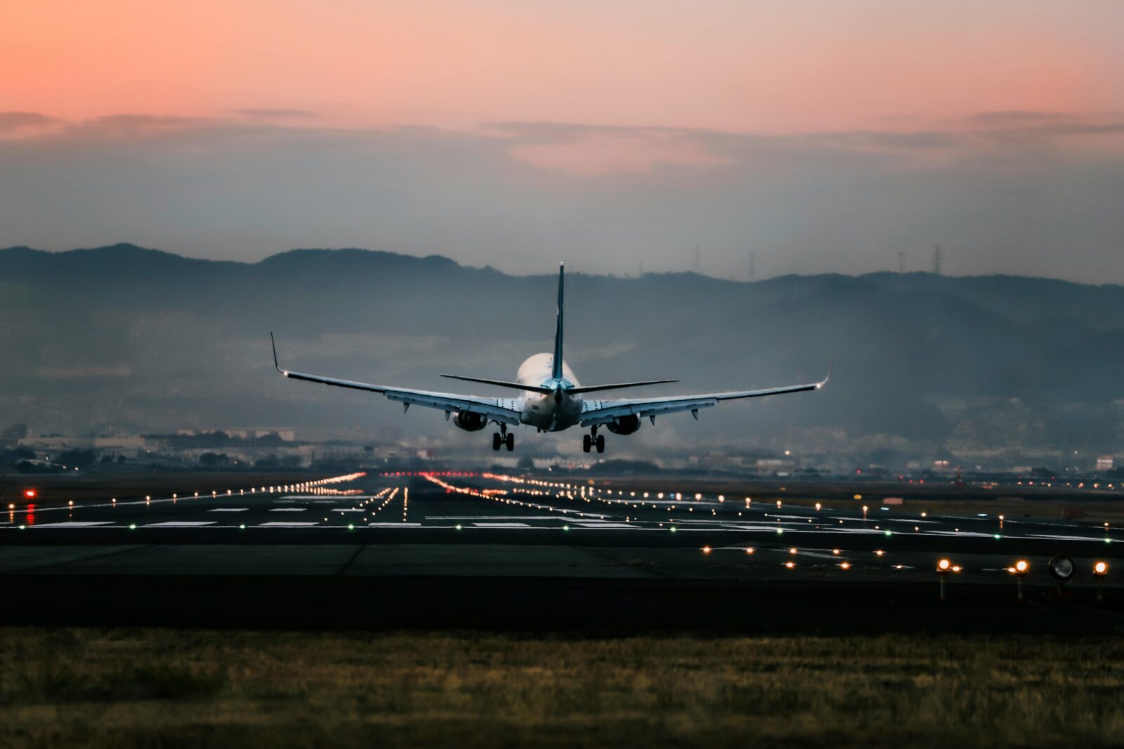 A commercial plane taking off at sunset