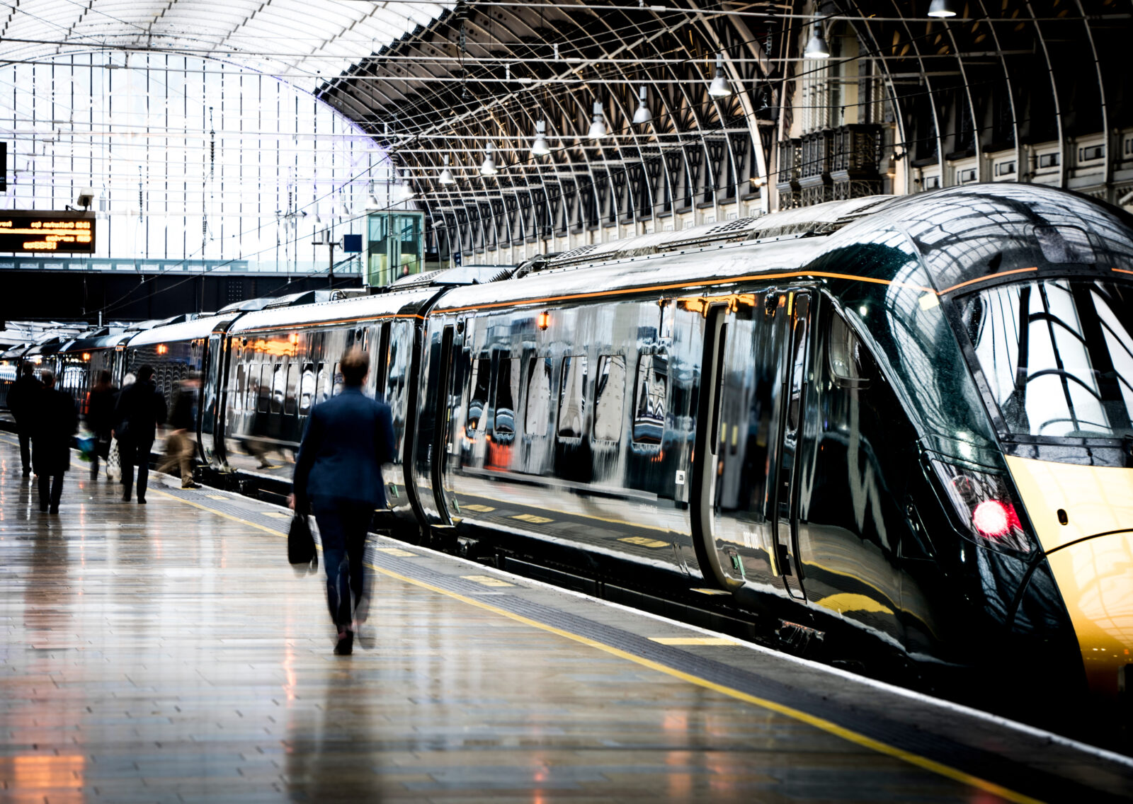 Train Station Platform With Motion Blurred People Walking representing the transport sector