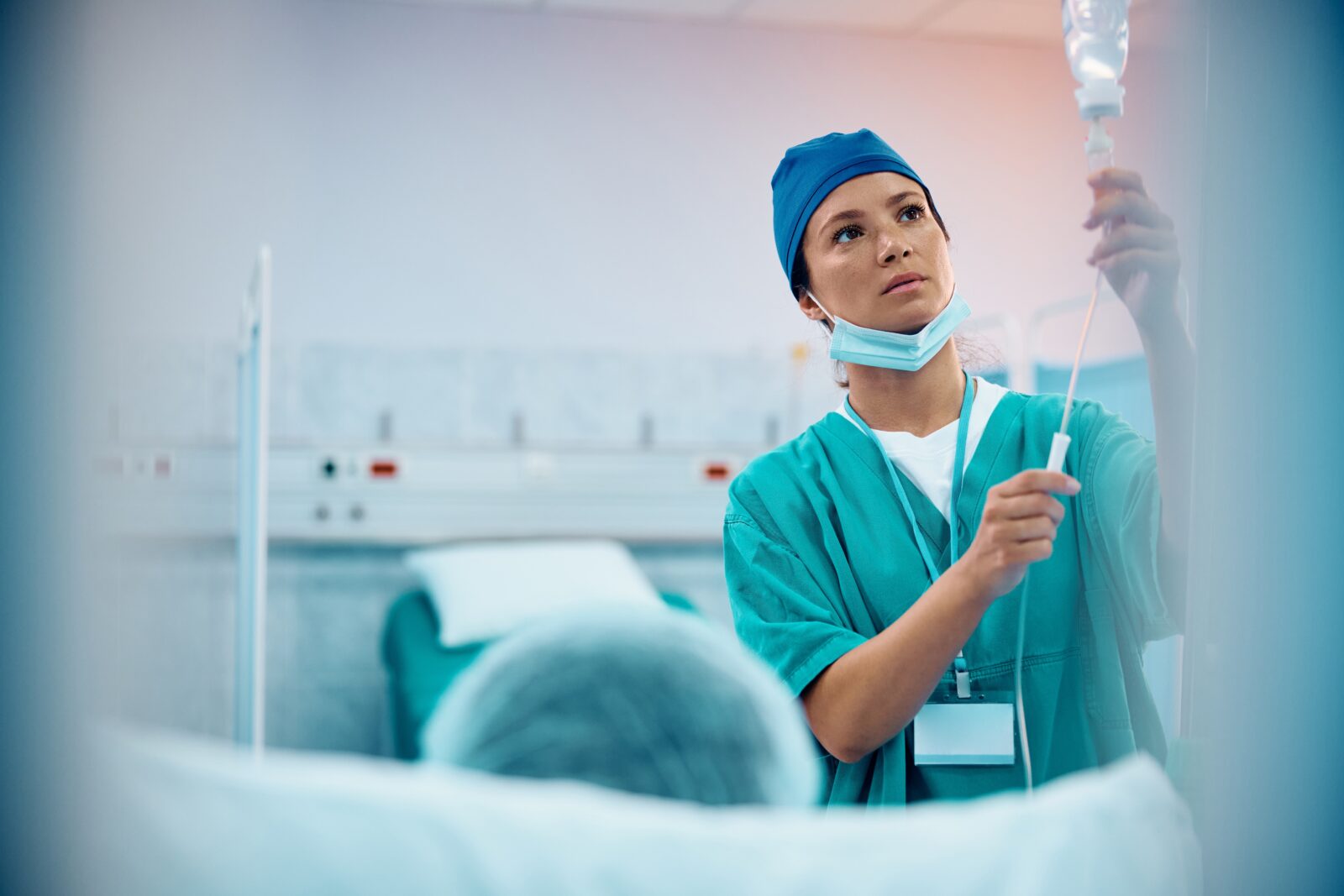 Mid Adult Nurse Taking Care Of A Patient At Intensive Care Unit