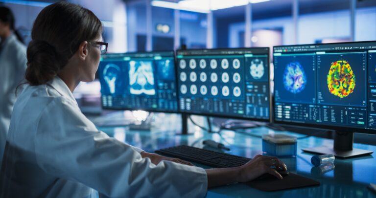 Female Neurologist Using a Desktop Computer