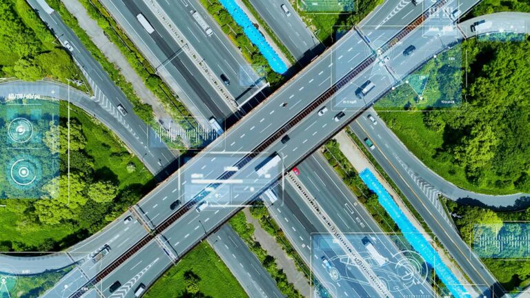 An aerial image of a cross section of busy roads surrounded by green fields