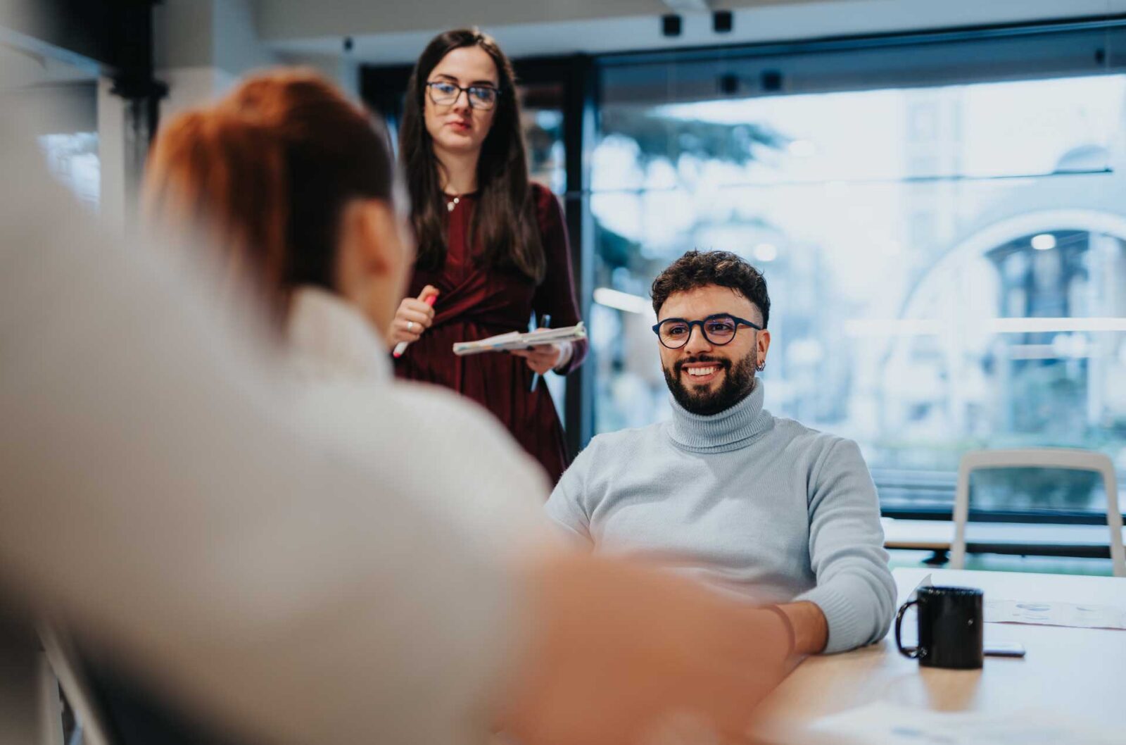Four professionals in discussion in office