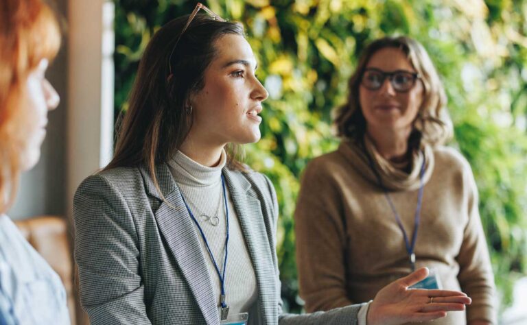 Three professional women in discussion