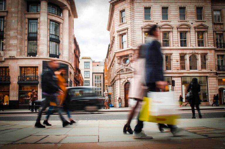 Motion blurred shoppers walking along London high street