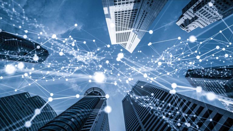 Ground-level view of skyscrapers with tech network overlay
