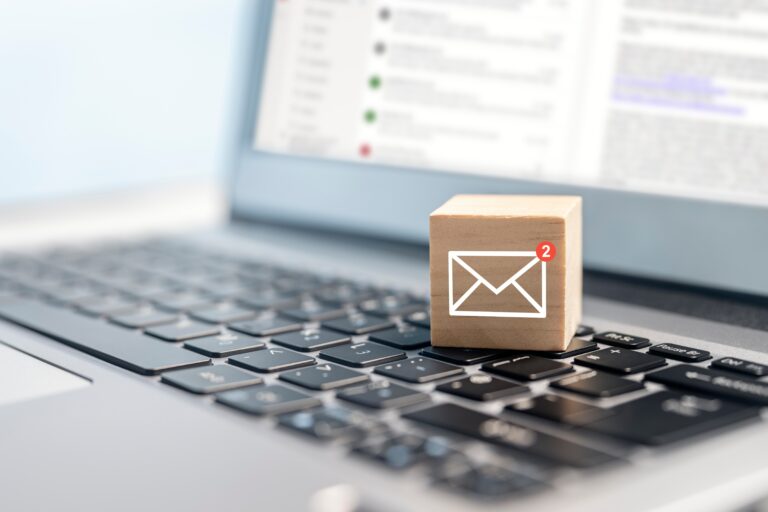 email symbol on wooden blocking showing unread messages on a laptop