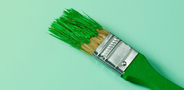 Green paintbrush covered in paint