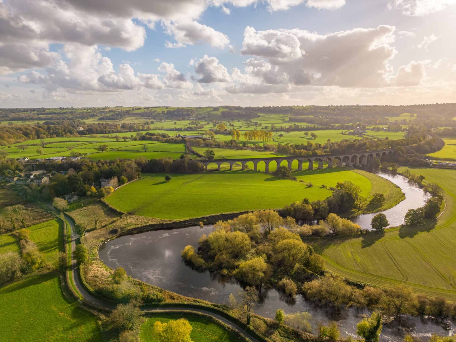 aerial view of meandering river and bridge