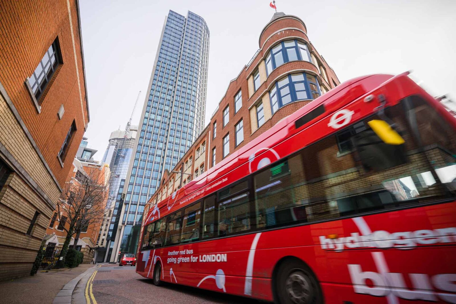 London hydrogen powered bus with skyscrapers in the background