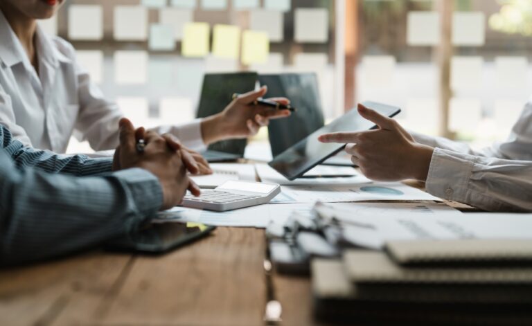 A table of business people collaborating and discussing business strategies an data