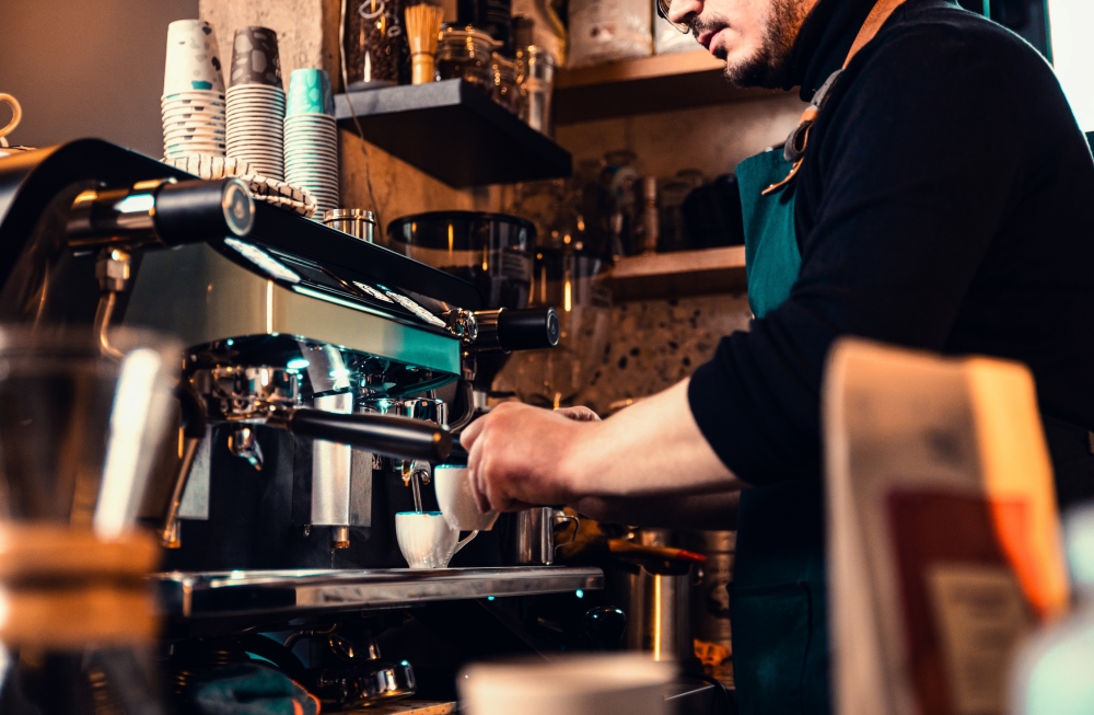 A barista preparing coffee in a modern coffee shop