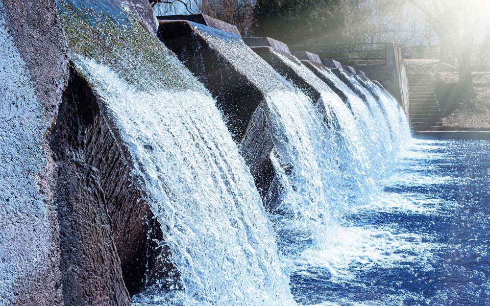 Water cascading through a series of channels at a water management structure