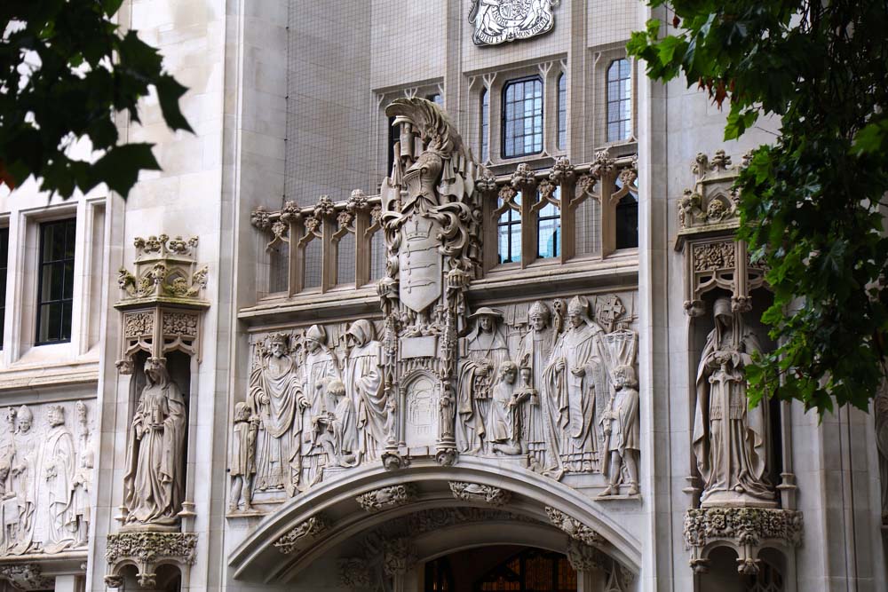 Ornate stone sculptures and architectural detailing above the entrance to the UK Supreme Court in London