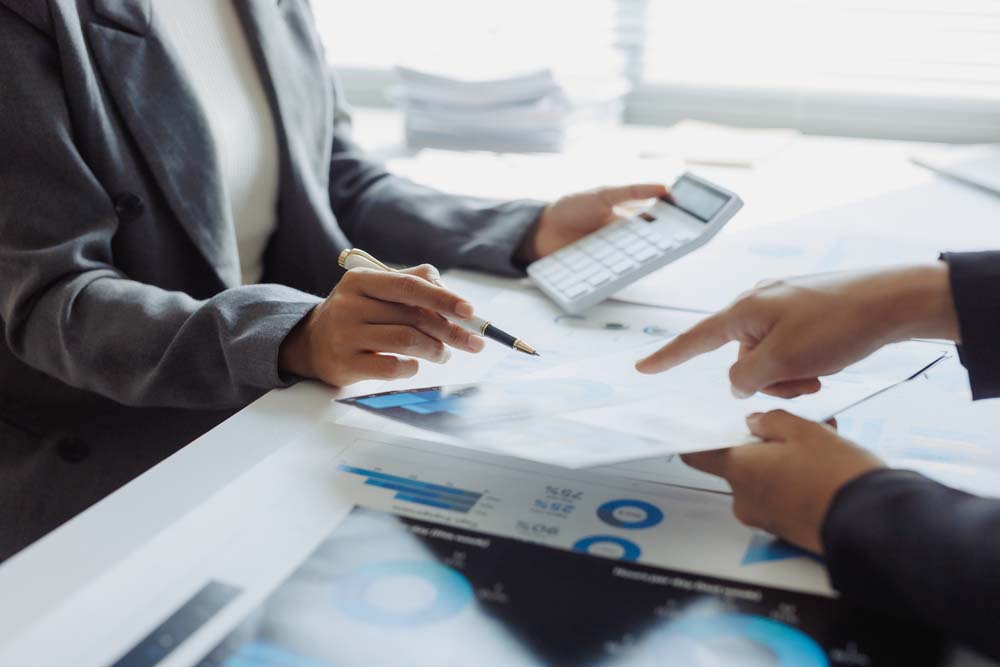People reviewing financial documents and figures on a desk