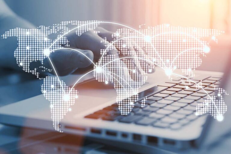 World map with digital network connections over a laptop keyboard
